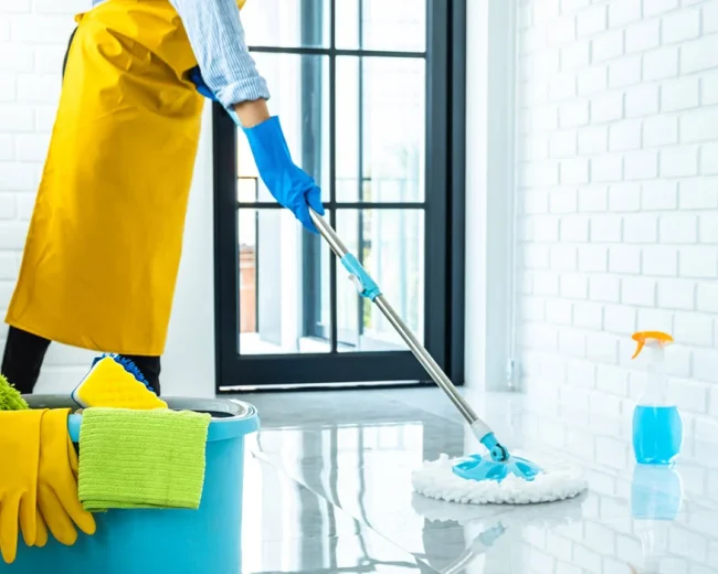 happy young woman blue rubber using mop while cleaning floor home