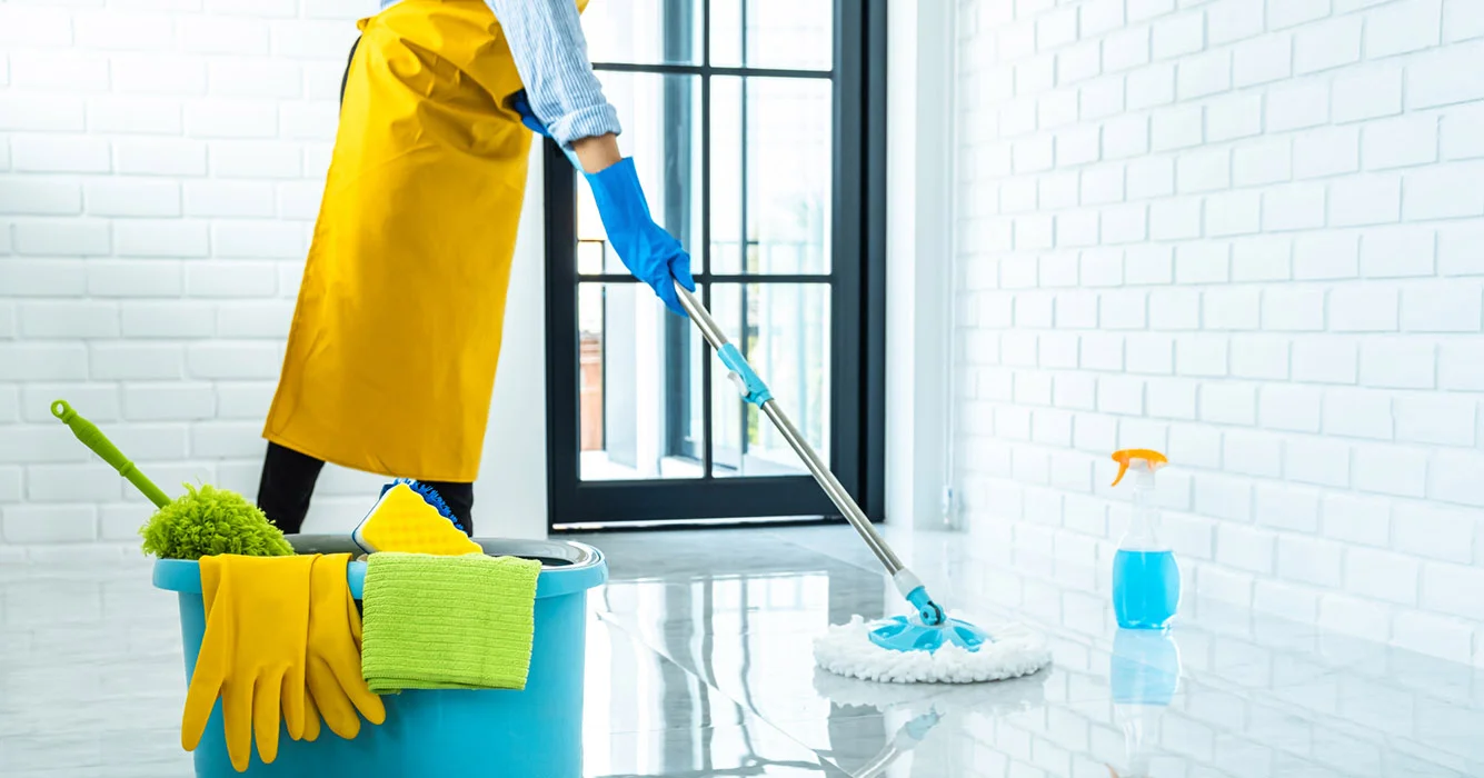 happy young woman blue rubber using mop while cleaning floor home