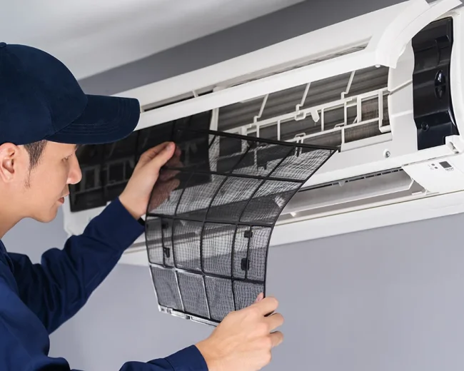 technician service removing air filter air conditioner cleaning