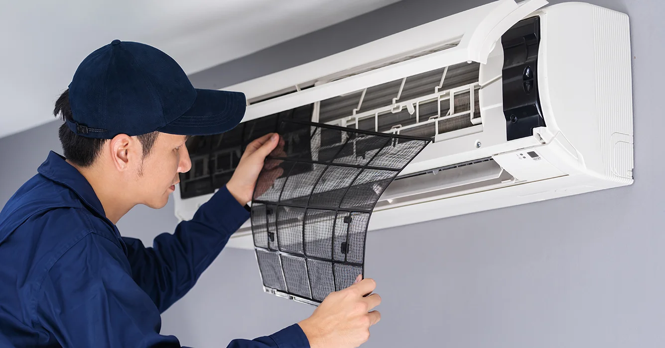 technician service removing air filter air conditioner cleaning